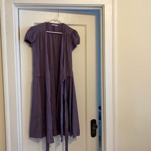 A light purple, vinal dress, two ties creating a wrap dress